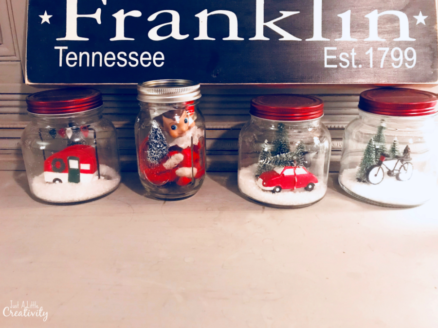 Elf on the shelf hiding in a Christmas mason jar
