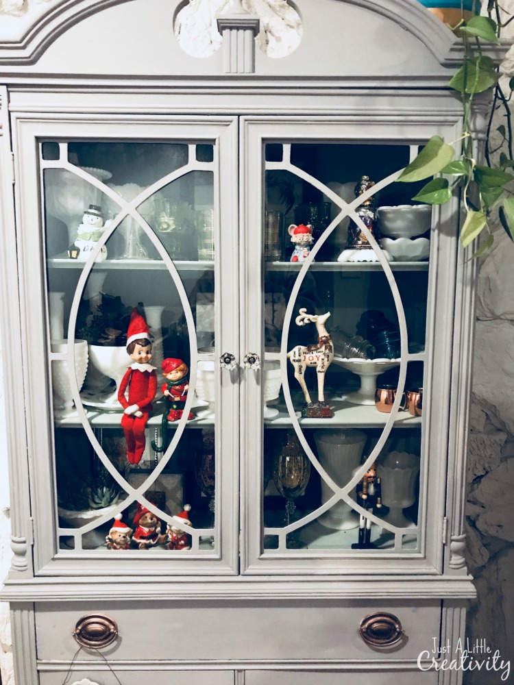 Hanging with the vintage Christmas decorations in the china cabinet