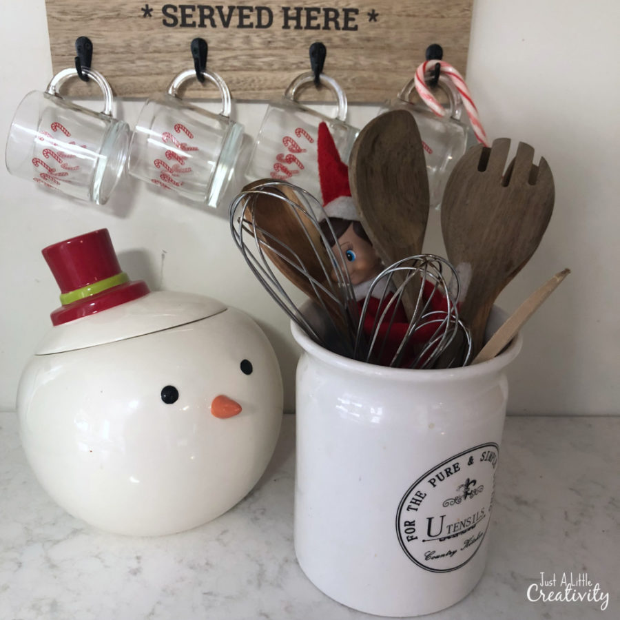 elf on the shelf hiding in the utensil holder