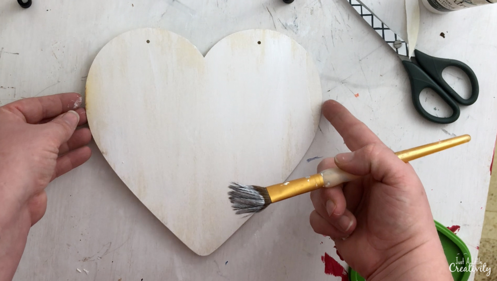 To make a farmhouse style heart, first paint it white