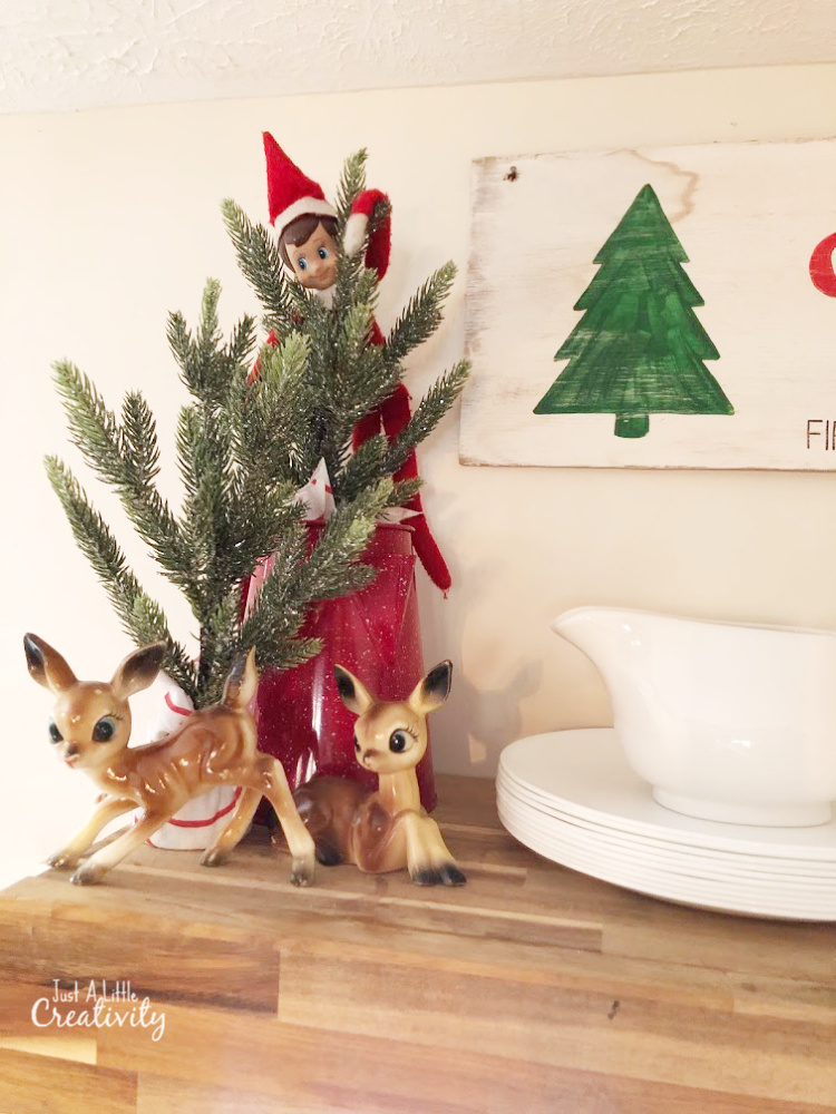 Elf on the Shelf hiding in a Christmas tree